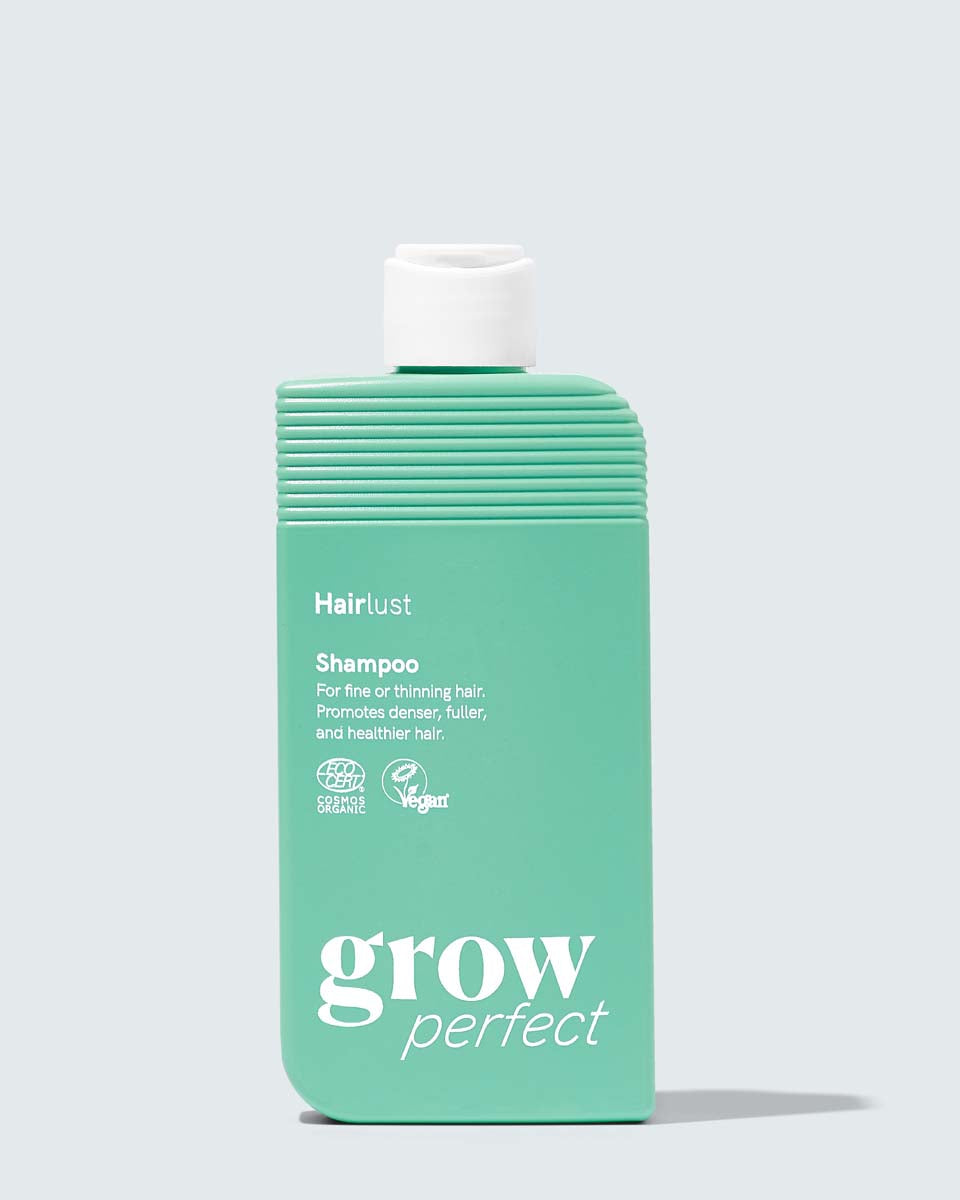 Flaske med Hairlust Grow Perfect shampoo til fint og tyndt hår